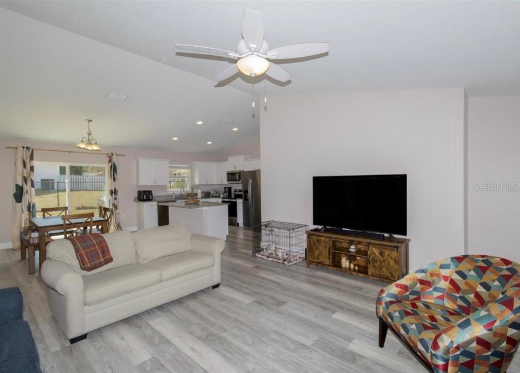 14 Hemlock Loop Court Ocala, FL 34472 - Photo 6 of 27 a living room with furniture and a flat screen tv