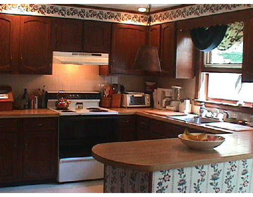 155 Swift Road Northbridge, MA 01588 - Photo 2 of 6 a kitchen with a sink a stove and black wooden cabinets