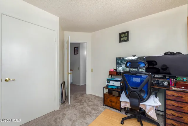 a bathroom with a granite countertop toilet sink and mirror