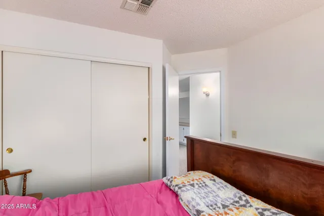a bathroom with a granite countertop sink a mirror a bathtub and shower