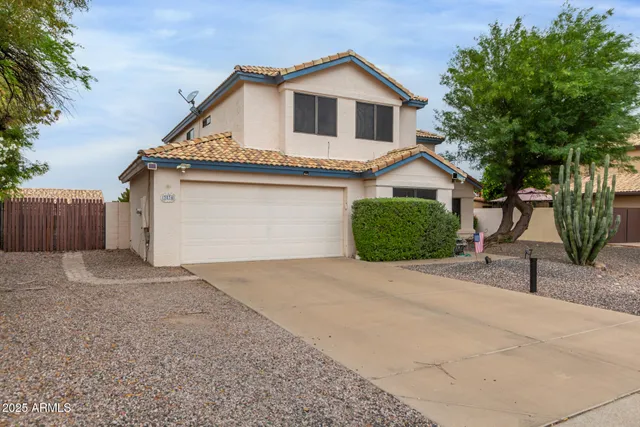 a view of a house with a yard and garage