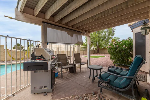a view of a house with a backyard and a tree