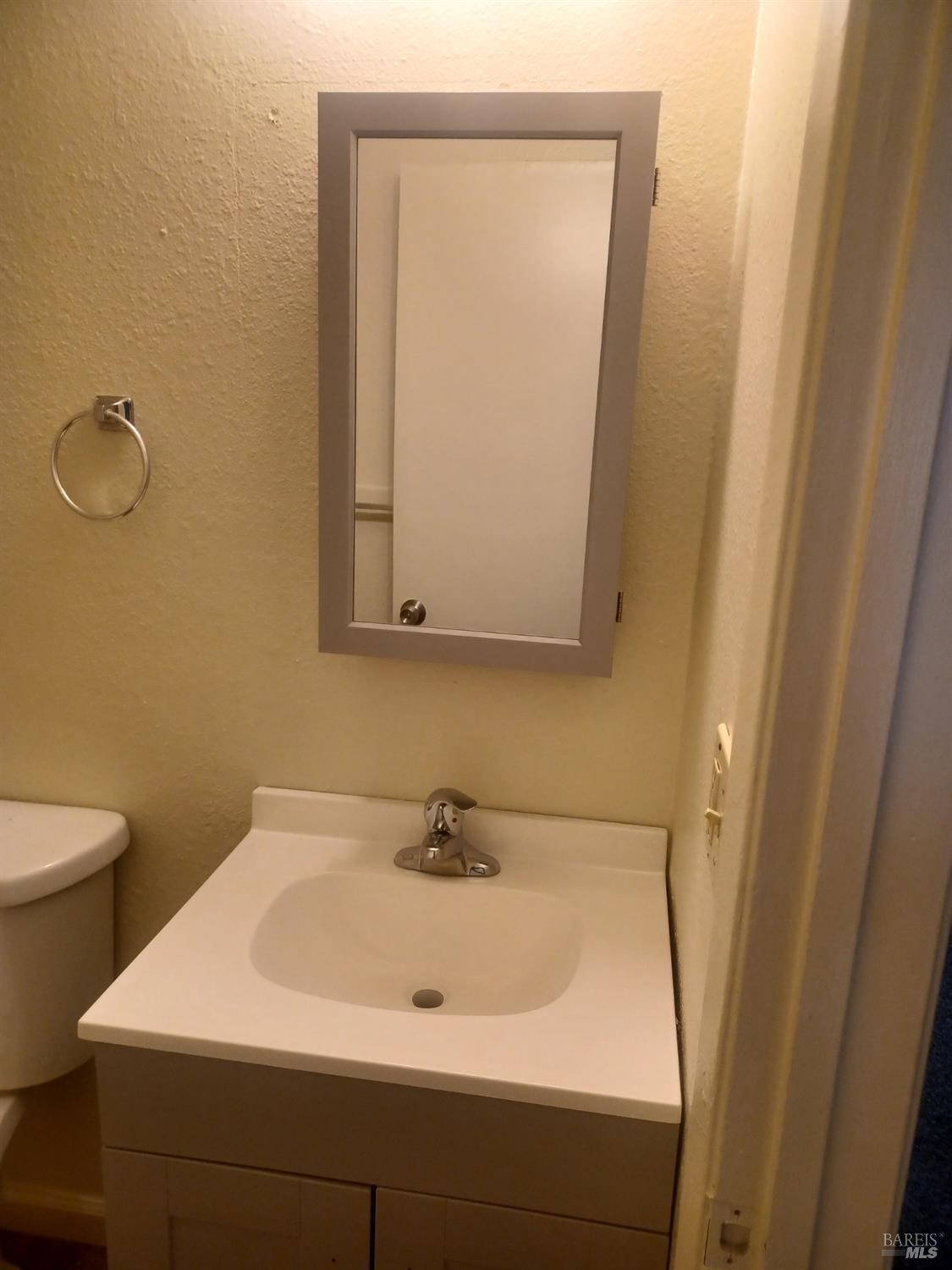 1925 Grande Circle, Unit 10 Fairfield, CA 94533 - Photo 11 of 12 a bathroom with a sink a toilet and a mirror