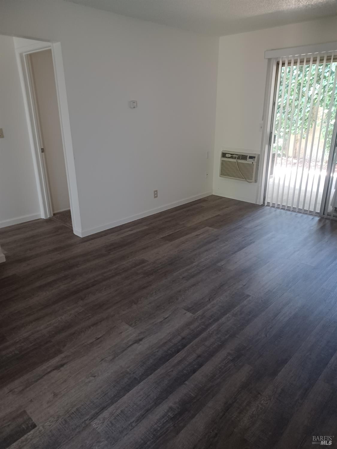 1925 Grande Circle, Unit 10 Fairfield, CA 94533 - Photo 4 of 12 an empty room with wooden floor and windows