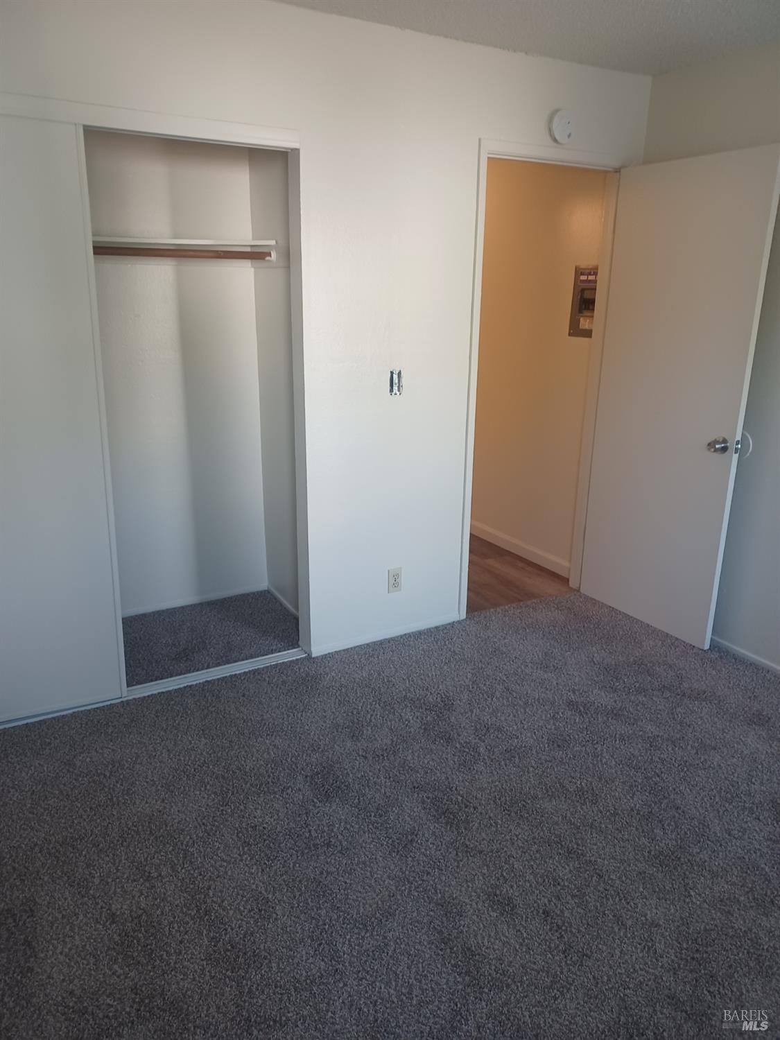 1925 Grande Circle, Unit 10 Fairfield, CA 94533 - Photo 9 of 12 an empty room with closet and wooden door