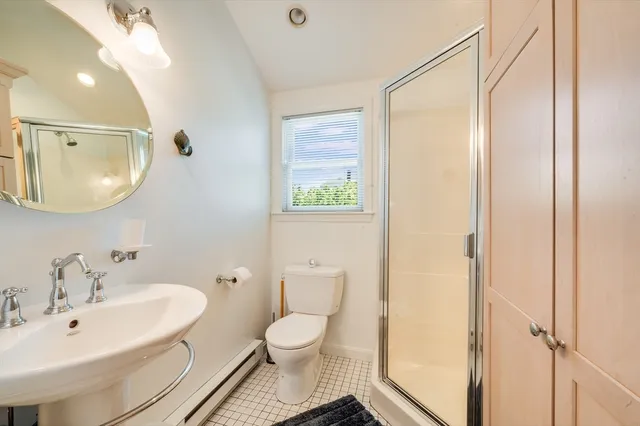 a bathroom with a toilet a sink and a mirror