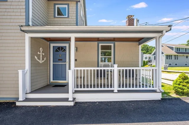 a view of a house with a small yard and wooden floor and fence