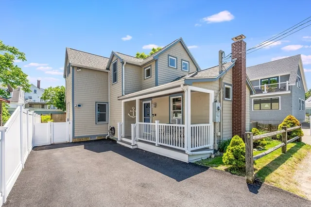 a view of a house with wooden fence