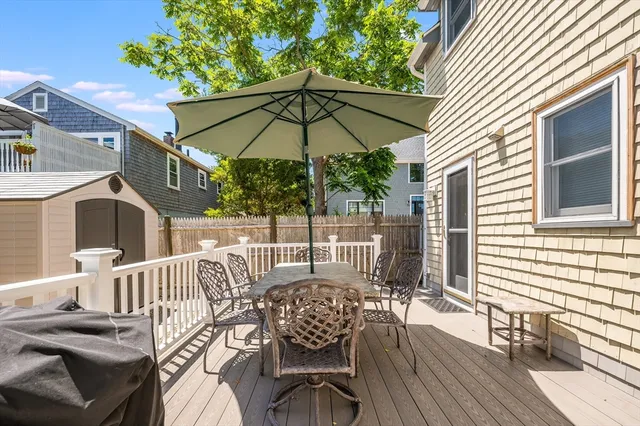 a patio with a table and chairs under an umbrella