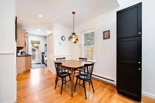 a view of a dining room with furniture and a chandelier