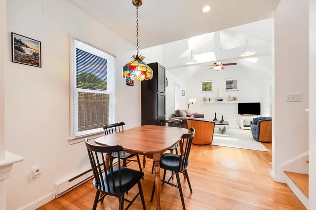a view of a dining room with furniture and wooden floor