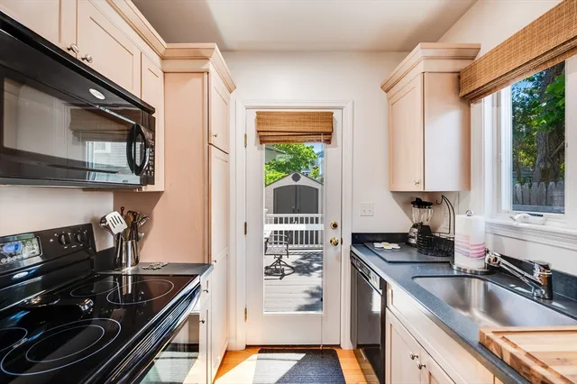 a kitchen with a sink a stove and cabinets