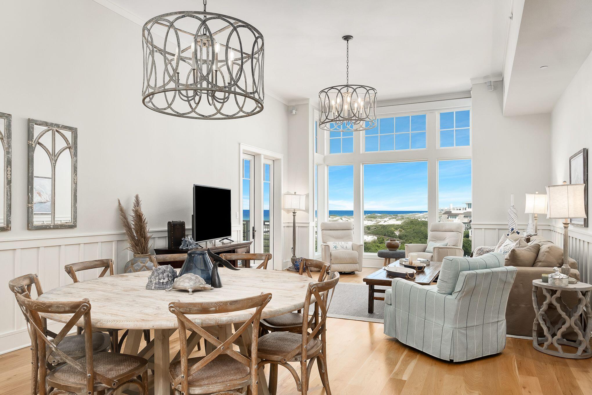 99 Compass Point Way South, Unit 406 Watersound, FL 32461 - Photo 1 of 41 a view of a dining room with furniture wooden floor and chandelier