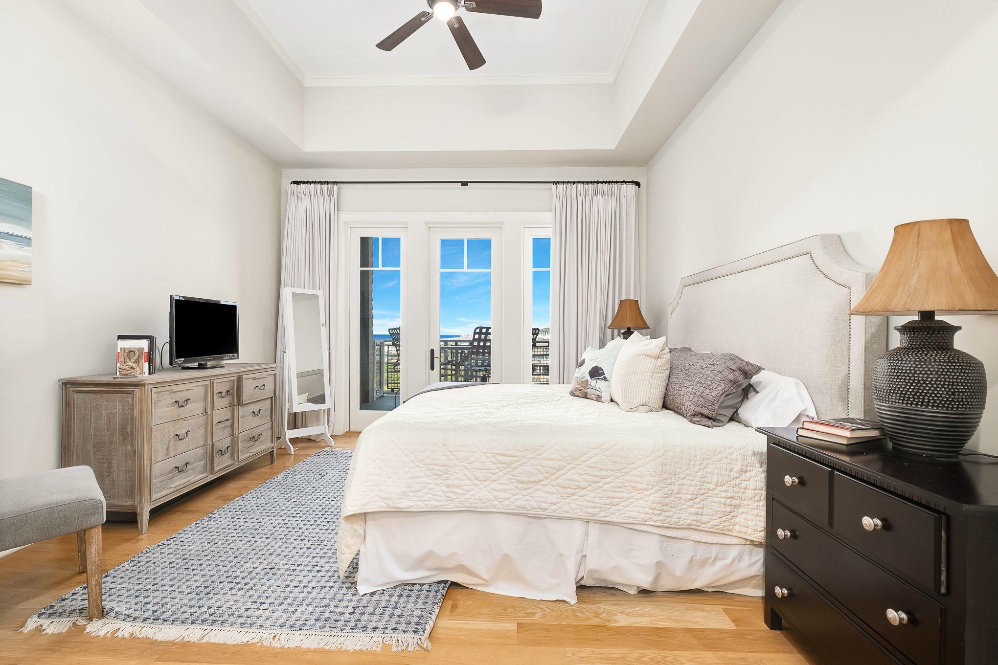 99 Compass Point Way South, Unit 406 Watersound, FL 32461 - Photo 12 of 41 a bedroom with a bed and a flat screen tv