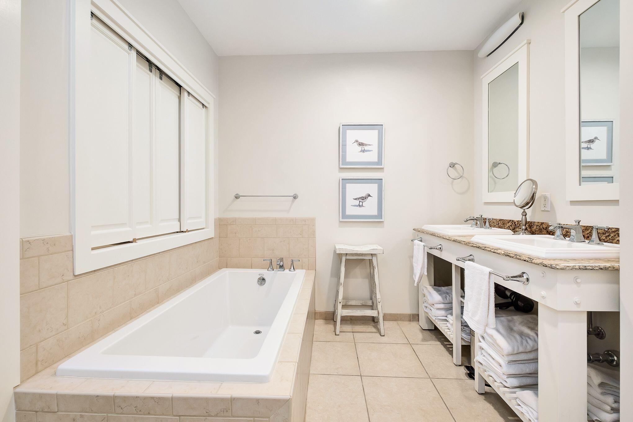 99 Compass Point Way South, Unit 406 Watersound, FL 32461 - Photo 14 of 41 a spacious bathroom with a tub sink and mirror