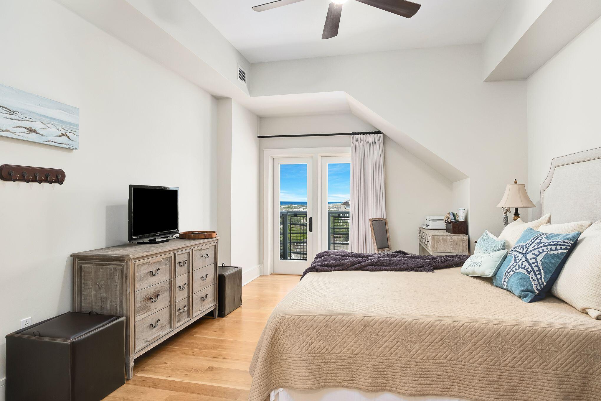 99 Compass Point Way South, Unit 406 Watersound, FL 32461 - Photo 17 of 41 a bedroom with a bed and a flat screen tv