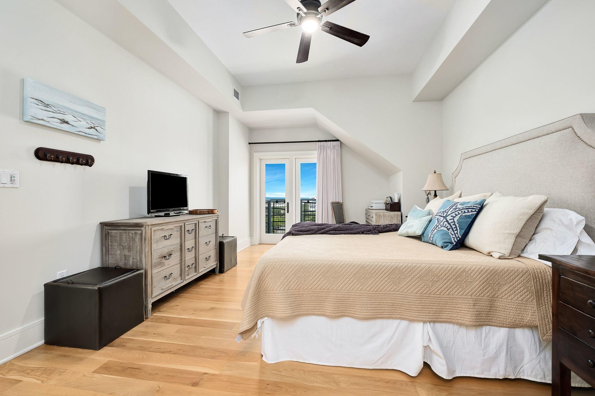 99 Compass Point Way South, Unit 406 Watersound, FL 32461 - Photo 18 of 41 a bedroom with a bed and a flat screen tv
