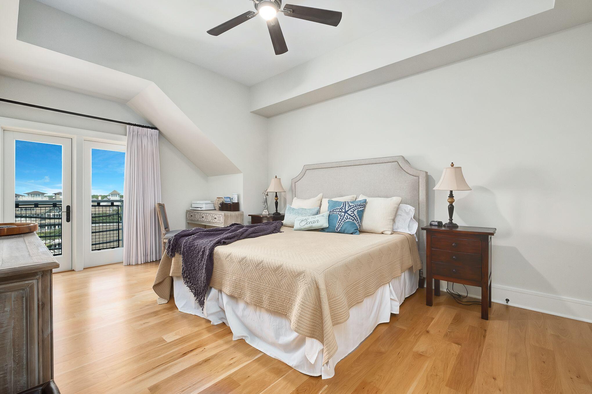 99 Compass Point Way South, Unit 406 Watersound, FL 32461 - Photo 19 of 41 a bedroom with a bed and a chandelier