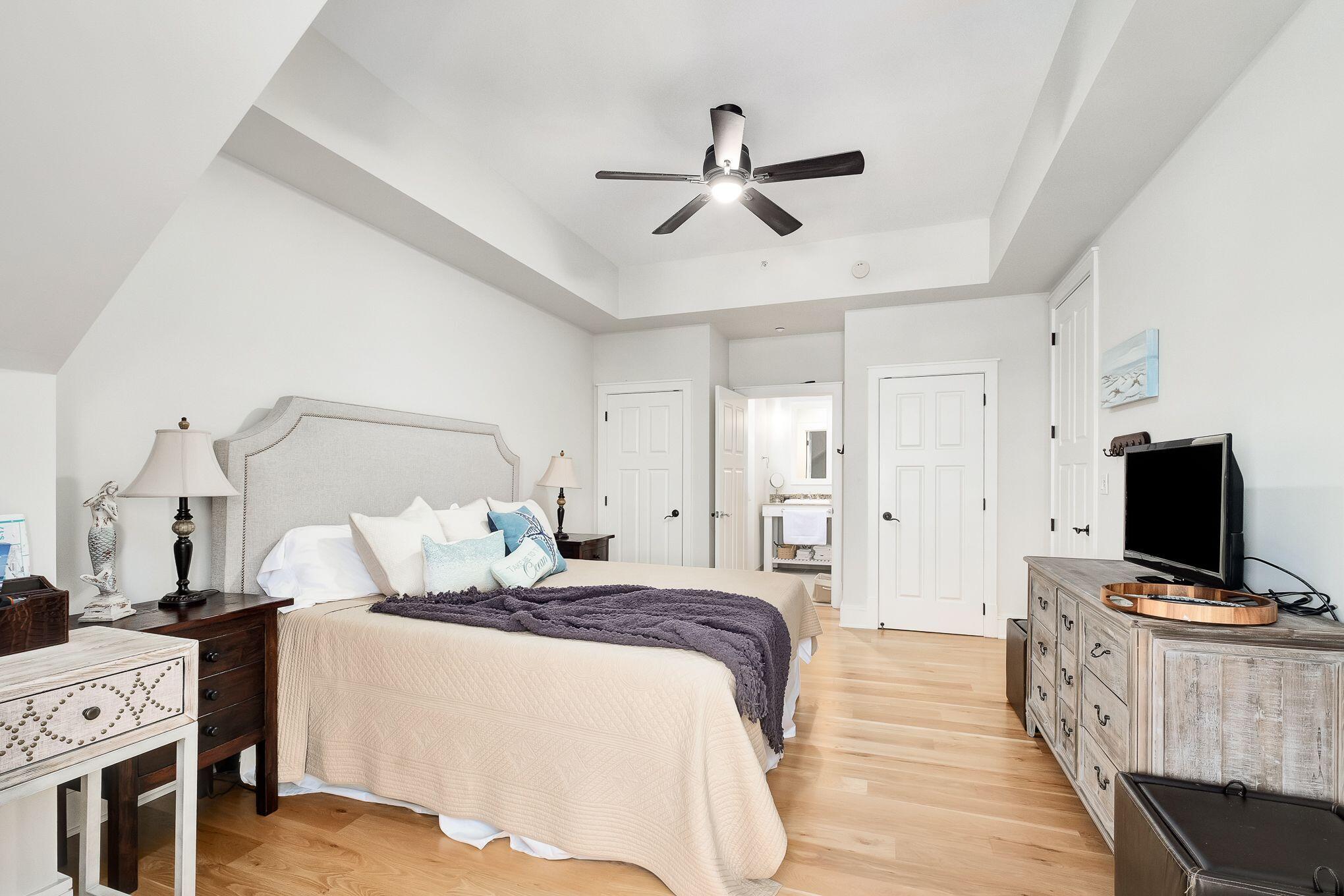 99 Compass Point Way South, Unit 406 Watersound, FL 32461 - Photo 20 of 41 a bedroom with a bed and a flat screen tv