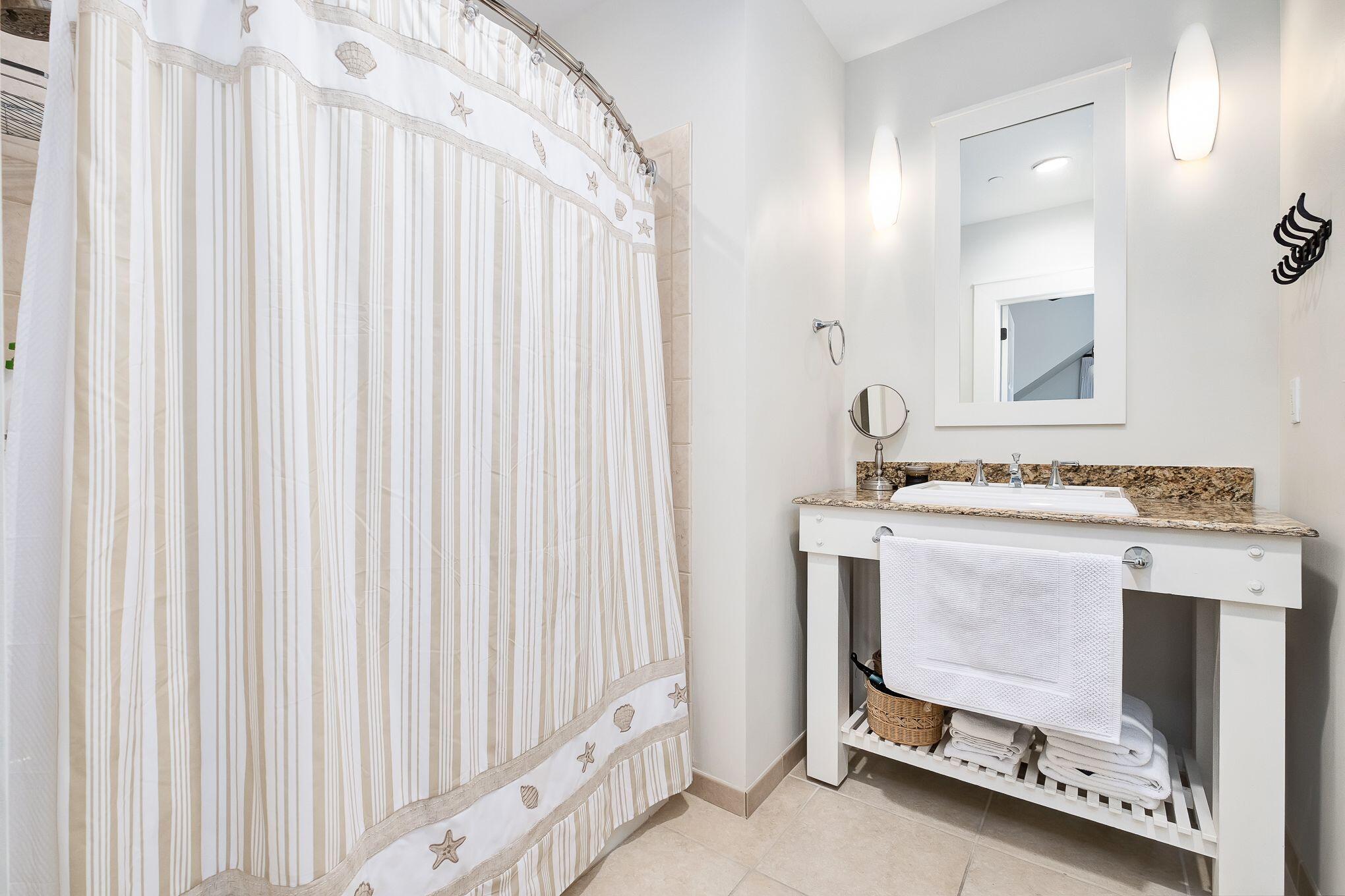 99 Compass Point Way South, Unit 406 Watersound, FL 32461 - Photo 21 of 41 a bathroom with a sink and a mirror