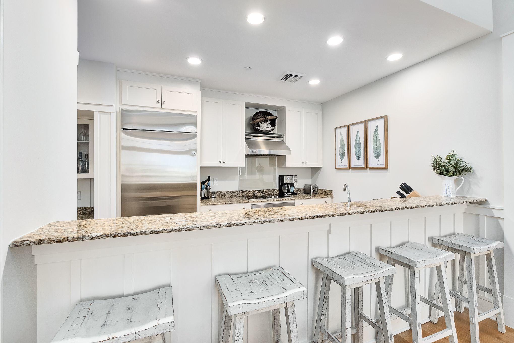 99 Compass Point Way South, Unit 406 Watersound, FL 32461 - Photo 29 of 41 a kitchen with granite countertop a sink and white cabinets