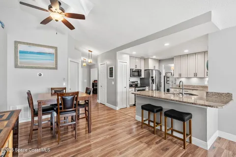 a view of a dining room with furniture and a chandelier