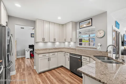 a kitchen with a sink stove and cabinets