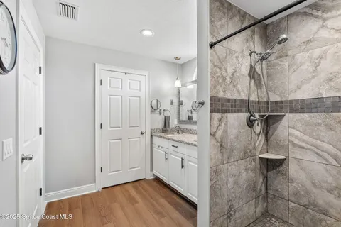 a bathroom with a shower and a sink