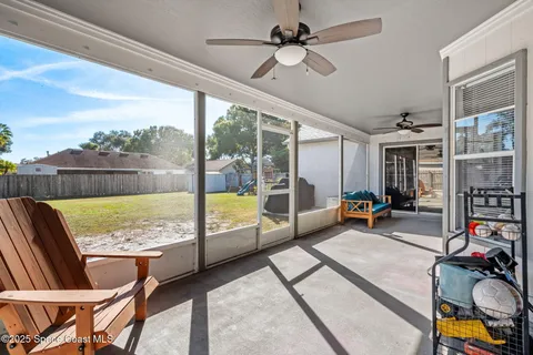 a view of a livingroom with furniture hardwood floor and a floor to ceiling window