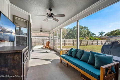 a living room with furniture and a floor to ceiling window