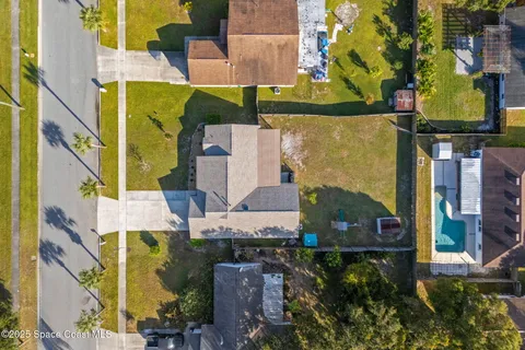 an aerial view of residential houses with outdoor space