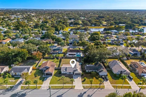 an aerial view of a houses with a swimming pool