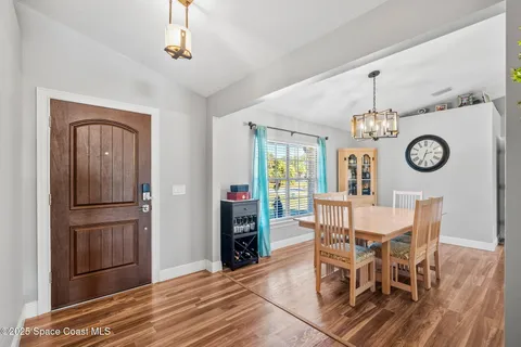 a view of a dining room with furniture and a window