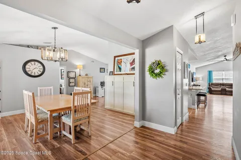 a view of a dining room with furniture wooden floor and a chandelier
