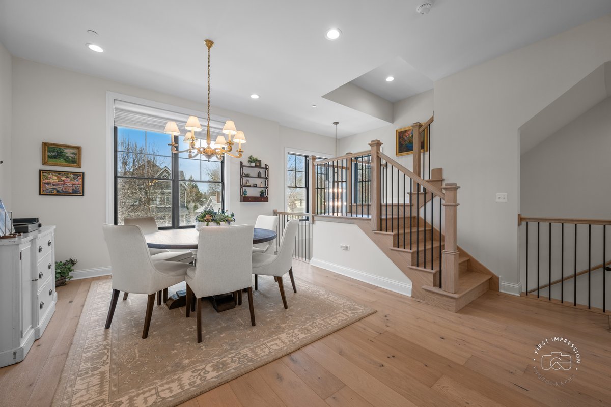 108 North Wright Street Naperville, IL 60540 - Photo 15 of 47 a view of a dining room and livingroom with furniture wooden floor a chandelier