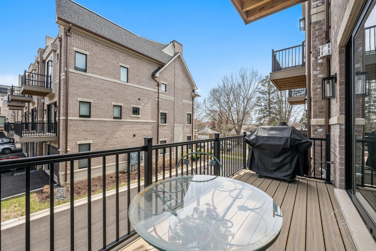 108 North Wright Street Naperville, IL 60540 - Photo 26 of 47 a view of a balcony with two chairs and wooden floor