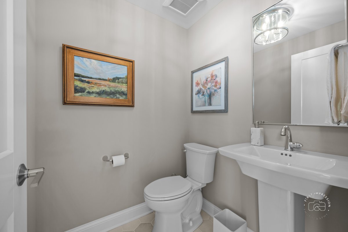 108 North Wright Street Naperville, IL 60540 - Photo 38 of 47 a bathroom with a toilet sink and mirror