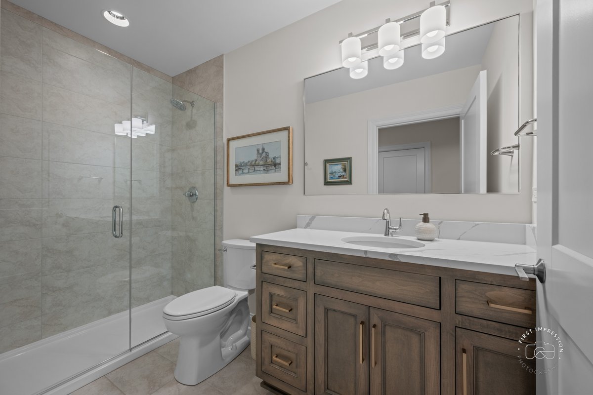 108 North Wright Street Naperville, IL 60540 - Photo 42 of 47 a bathroom with a granite countertop sink a toilet and a mirror