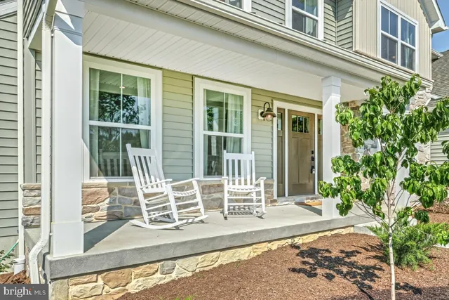 a view of a house with a large window and wooden fence