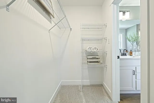 a view of walk in closet with empty racks
