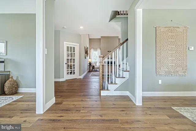 a view of entryway and hall with wooden floor