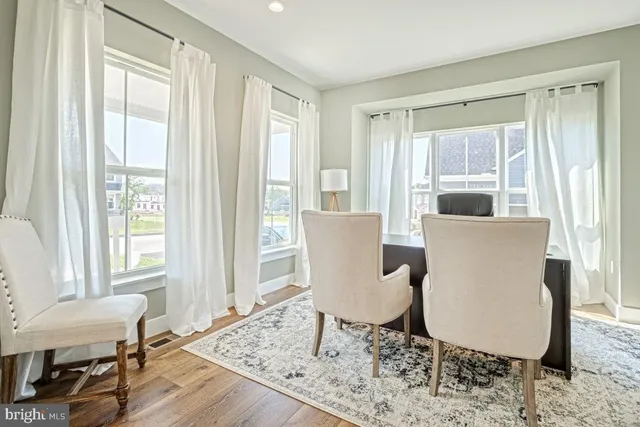 a view of a dining room with furniture window and wooden floor