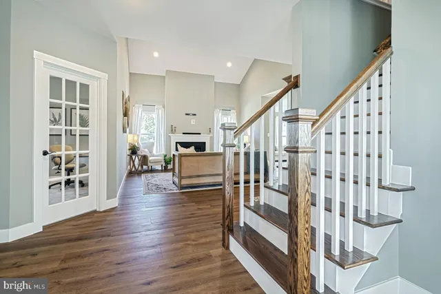 a view of entryway and hall with wooden floor