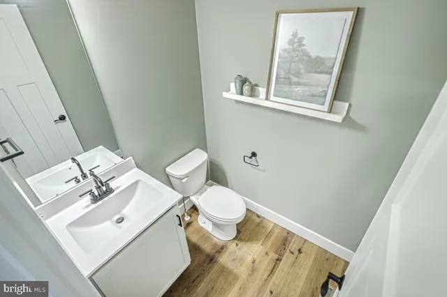a white toilet sitting next to a bathroom sink
