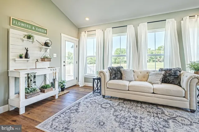 a living room with furniture and a window with outer view