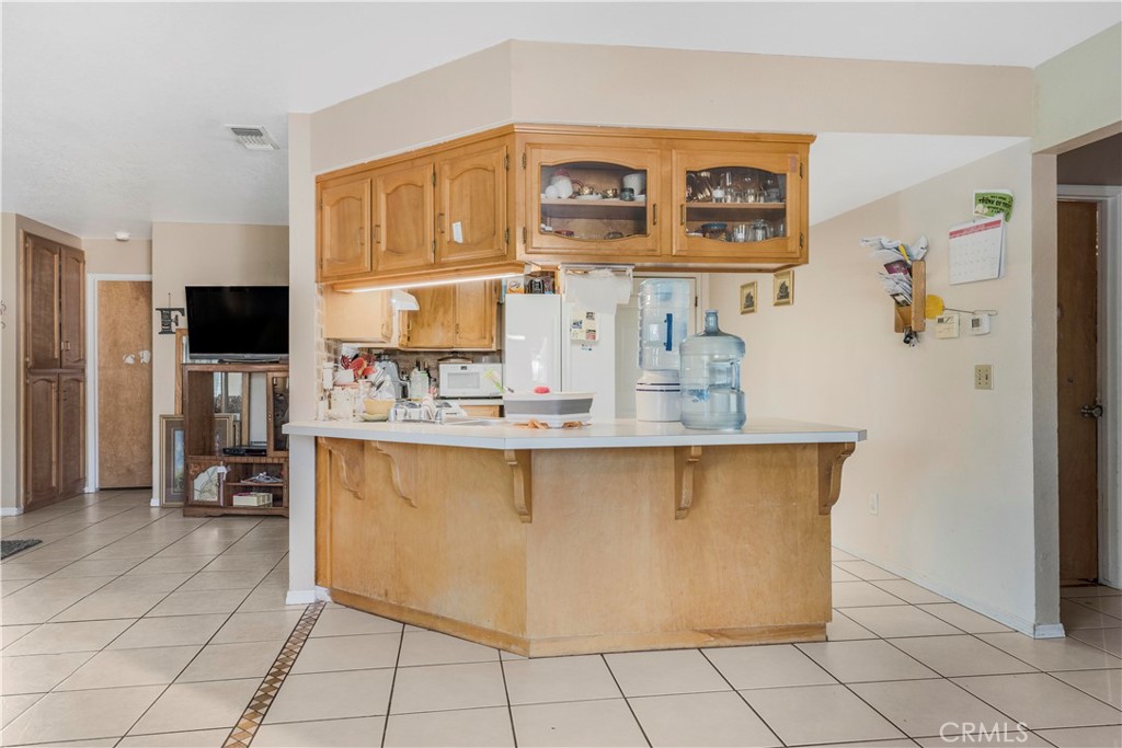 240 North 4th Street Shandon, CA 93461 - Photo 12 of 38 a kitchen with stainless steel appliances a stove top oven a sink and a refrigerator
