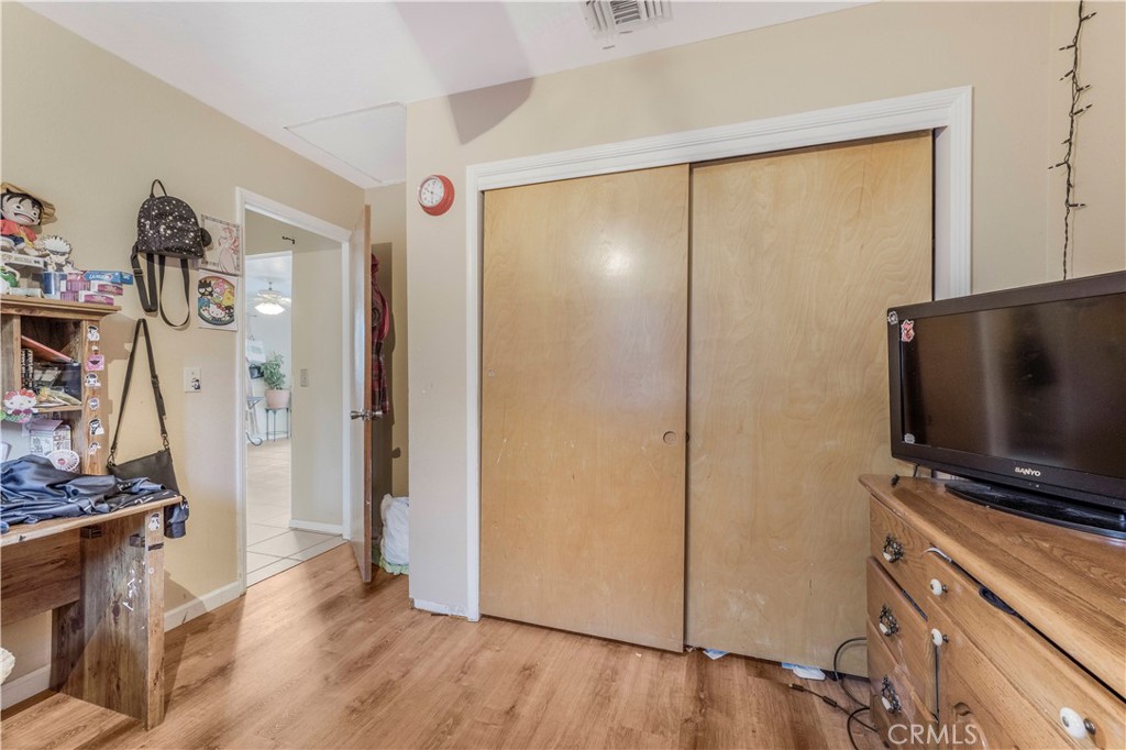 240 North 4th Street Shandon, CA 93461 - Photo 21 of 38 a view of a livingroom with wooden floor and a flat screen tv