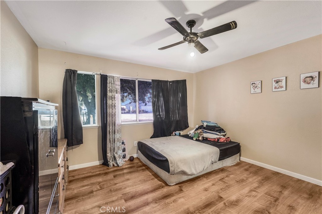 240 North 4th Street Shandon, CA 93461 - Photo 22 of 38 a bedroom with a bed and a large window