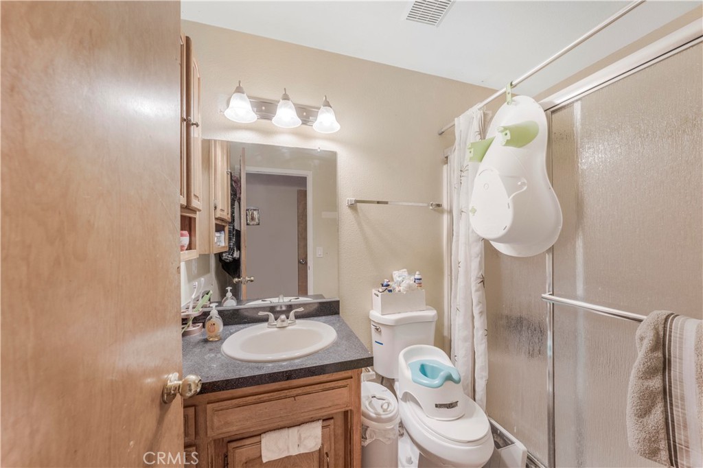 240 North 4th Street Shandon, CA 93461 - Photo 26 of 38 a bathroom with a sink a toilet and a mirror