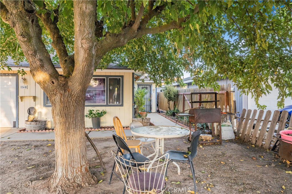 240 North 4th Street Shandon, CA 93461 - Photo 5 of 38 a backyard of a house with barbeque oven table and chairs